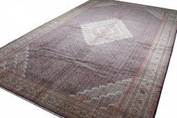 Corner detail of 2000s Tabriz rug showing border pattern and Wool pile