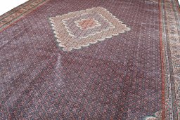 Backside of handmade 2000s Tabriz rug showing knot structure and weave density