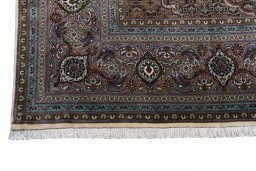 Backside of handmade New Tabriz rug showing knot structure and weave density