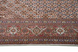 Corner detail of New Tabriz rug showing border pattern and Cork pile