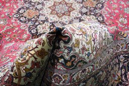 Corner detail of 2000s Tabriz rug showing border pattern and Cork pile