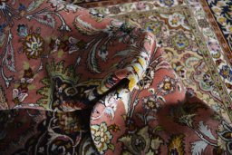 Backside of handmade New Tabriz rug showing knot structure and weave density