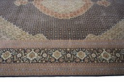 Corner detail of 2000s Tabriz rug showing border pattern and Cork pile