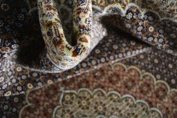 Surface texture of 2000s Tabriz rug with natural Cork and intricate pattern