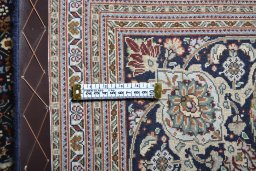 Backside of handmade 2000s Tabriz rug showing knot structure and weave density
