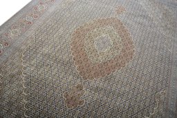 Backside of handmade New Tabriz rug showing knot structure and weave density