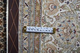 Backside of handmade 2000s Tabriz rug showing knot structure and weave density