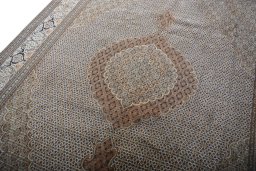 Backside of handmade 2000s Tabriz rug showing knot structure and weave density