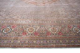 Corner detail of New Tabriz rug showing border pattern and Cork pile