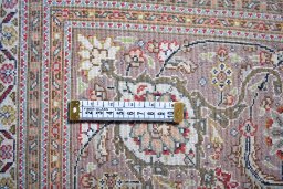 Backside of handmade New Tabriz rug showing knot structure and weave density