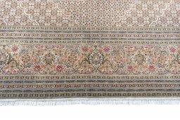Corner detail of 2000s Tabriz rug showing border pattern and Cork pile