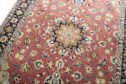 Backside of handmade New Tabriz rug showing knot structure and weave density