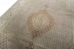 Backside of handmade 2000s Tabriz rug showing knot structure and weave density