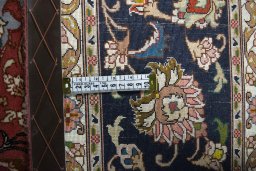 Backside of handmade New Tabriz rug showing knot structure and weave density