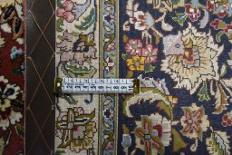 Backside of handmade New Tabriz rug showing knot structure and weave density