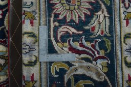 Backside of handmade 2000s Tabriz rug showing knot structure and weave density