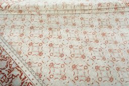 Corner detail of 2000s Tabriz rug showing border pattern and Wool pile