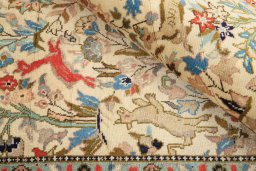 Corner detail of 2000s Tabriz rug showing border pattern and Wool pile