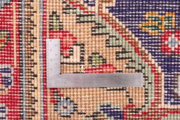 Corner detail of 1996s Tabriz rug showing border pattern and Wool pile
