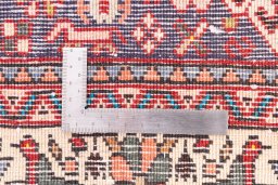 Corner detail of 1973s Tabriz rug showing border pattern and Wool pile
