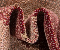 Backside of handmade New Tabriz rug showing knot structure and weave density