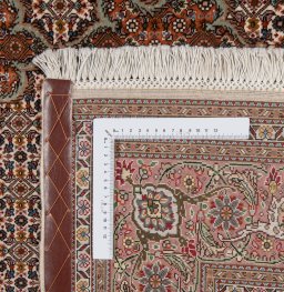 Backside of handmade New Tabriz rug showing knot structure and weave density
