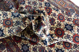 Corner detail of 2000s Varamin rug showing border pattern and Wool pile