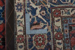 Backside of handmade 1950s Varamin rug showing knot structure and weave density
