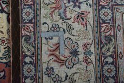 Backside of handmade 2000s Yazd rug showing knot structure and weave density