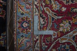 Backside of handmade 2000s Yazd rug showing knot structure and weave density