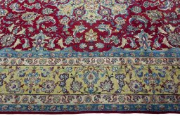 Corner detail of 2000s Yazd rug showing border pattern and Wool pile