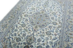 Backside of handmade 2000s Kashan rug showing knot structure and weave density