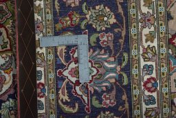 Backside of handmade New Tabriz 50/60/70 Raj rug showing knot structure and weave density
