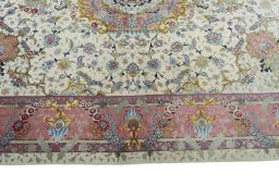 Corner detail of 2000s Tabriz 50/60/70 Raj rug showing border pattern and Cork pile