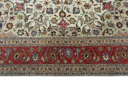 Corner detail of 2000s Tabriz 50/60/70 Raj rug showing border pattern and Cork pile