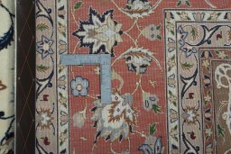Backside of handmade 2000s Tabriz 50/60/70 Raj rug showing knot structure and weave density
