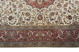 Corner detail of 2000s Tabriz 50/60/70 Raj rug showing border pattern and Cork pile