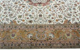 Corner detail of 2000s Tabriz 50/60/70 Raj rug showing border pattern and Cork pile
