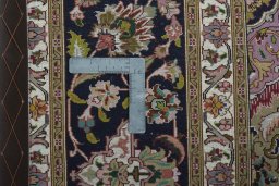 Backside of handmade 2000s Tabriz 50/60/70 Raj rug showing knot structure and weave density