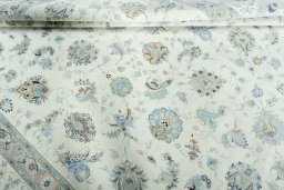 Corner detail of 2000s Tabriz 50/60/70 Raj rug showing border pattern and Cork pile