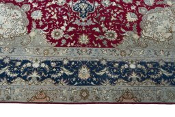 Corner detail of 2000s Tabriz 50/60/70 Raj rug showing border pattern and Cork pile