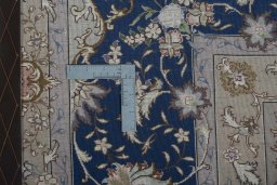 Backside of handmade 2000s Tabriz 50/60/70 Raj rug showing knot structure and weave density