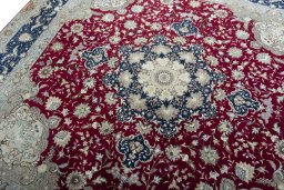 Backside of handmade 2000s Tabriz 50/60/70 Raj rug showing knot structure and weave density