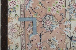 Backside of handmade 2000s Tabriz 50/60/70 Raj rug showing knot structure and weave density