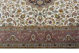 Corner detail of 2000s Tabriz 50/60/70 Raj rug showing border pattern and Cork pile