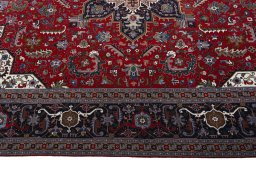 Corner detail of 2000s Tabriz 50/60/70 Raj rug showing border pattern and Cork pile