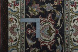 Backside of handmade 2000s Tabriz 50/60/70 Raj rug showing knot structure and weave density