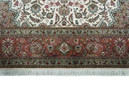 Corner detail of 2000s Tabriz 50/60/70 Raj rug showing border pattern and Cork pile