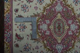 Corner detail of 2000s Tabriz 50/60/70 Raj rug showing border pattern and Cork pile