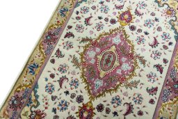 Backside of handmade 2000s Tabriz 50/60/70 Raj rug showing knot structure and weave density